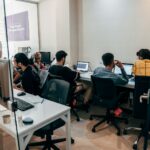 a group of people sitting at computers