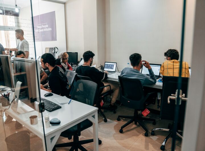 a group of people sitting at computers