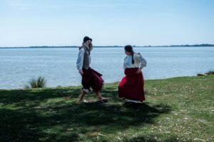 Gauchos performing a traditional dance by the lake in Chascomús, Argentina.