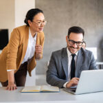 Portrait of successful multiethnic business people working, talking together in corporate office during work.